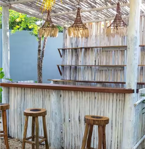 Outdoor bar area with wooden stools