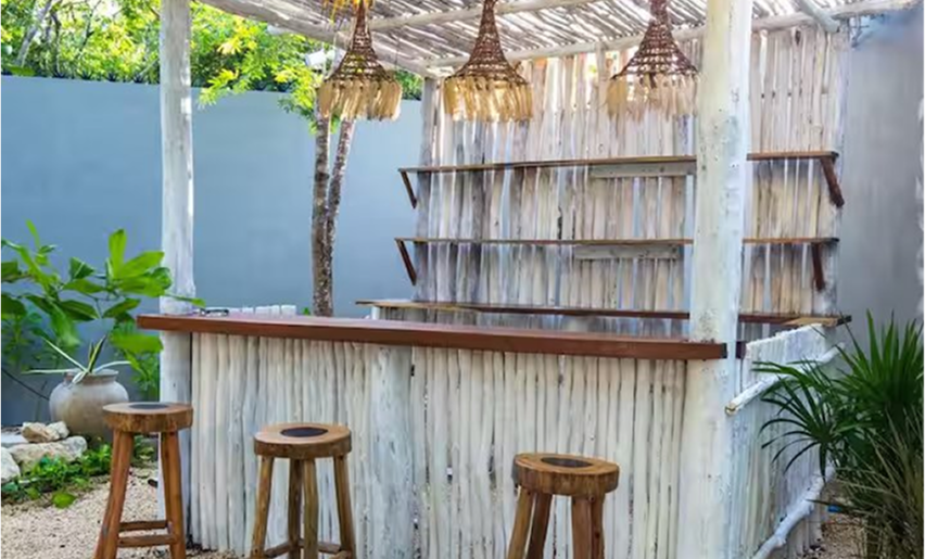 Outdoor bar area with wooden stools